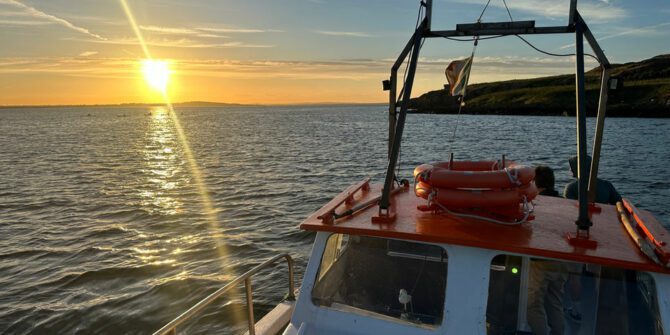 howth-sundown-cruise-irish-sunset-shimmers-on-ocean-waters-mid-cruise-offering-breathtaking-seaside-beauty-dublin-ireland