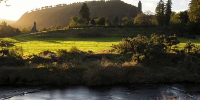 hilltop-treks-sunrise-over-ancient-stone-ruins-and-lakes-of-glendalough-ireland