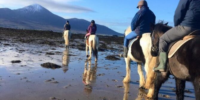Beach horse riding Clew Bay looking at Croagh Patrick County Mayo Ireland 2